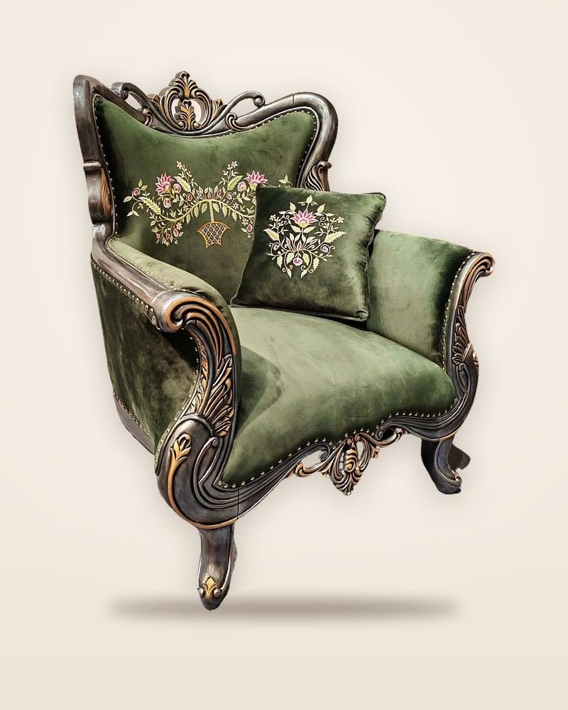 Carved wooden armchair with a velvet-covered seat and back