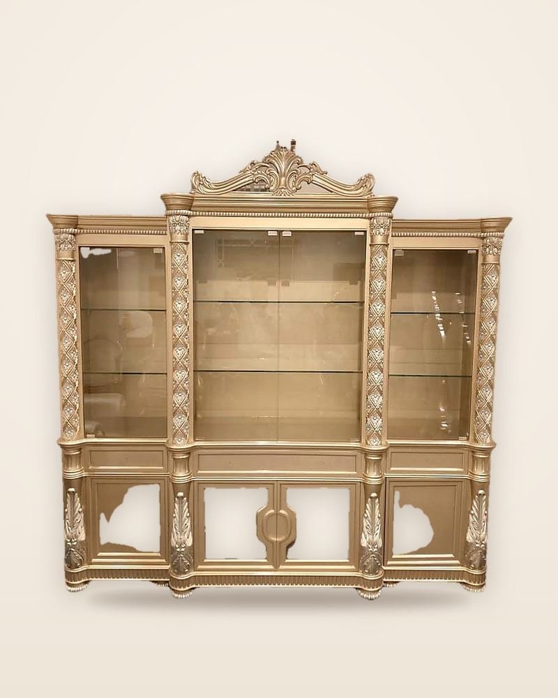 Display cabinet with a carved champagne-finish frame and glass shelves