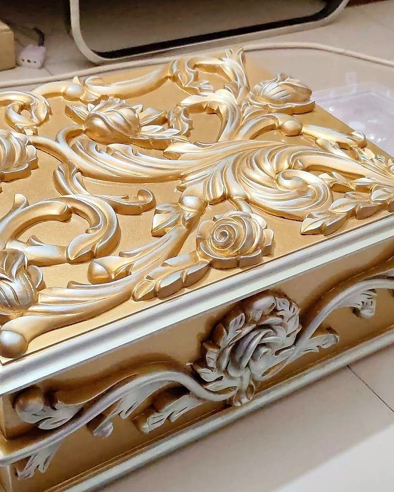 Close-up of hand-carved details on a wooden box