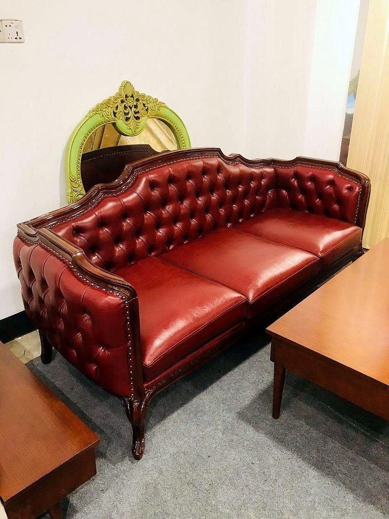 Chesterfield-style sofa with deep button details and rounded arms