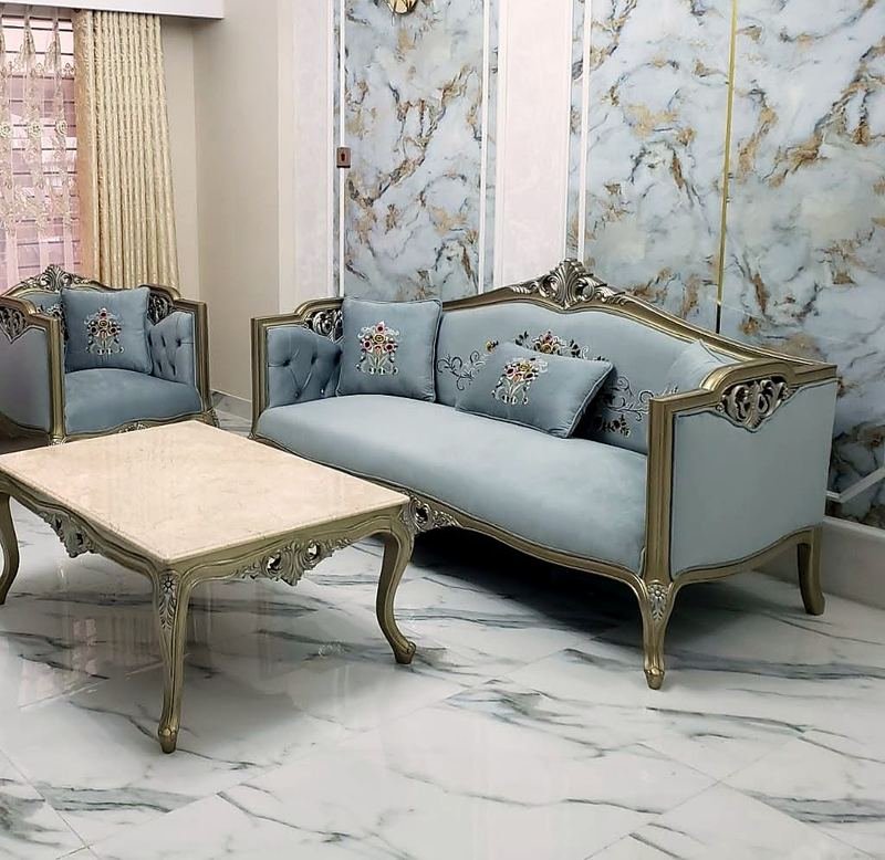 Living room with a carved sofa set, armchairs and a centre table