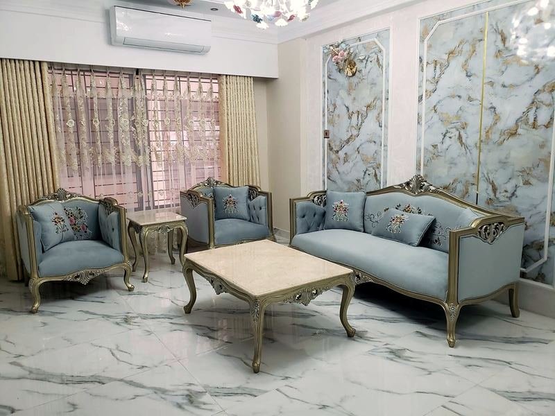 Living room with a carved sofa set, armchairs and a centre table