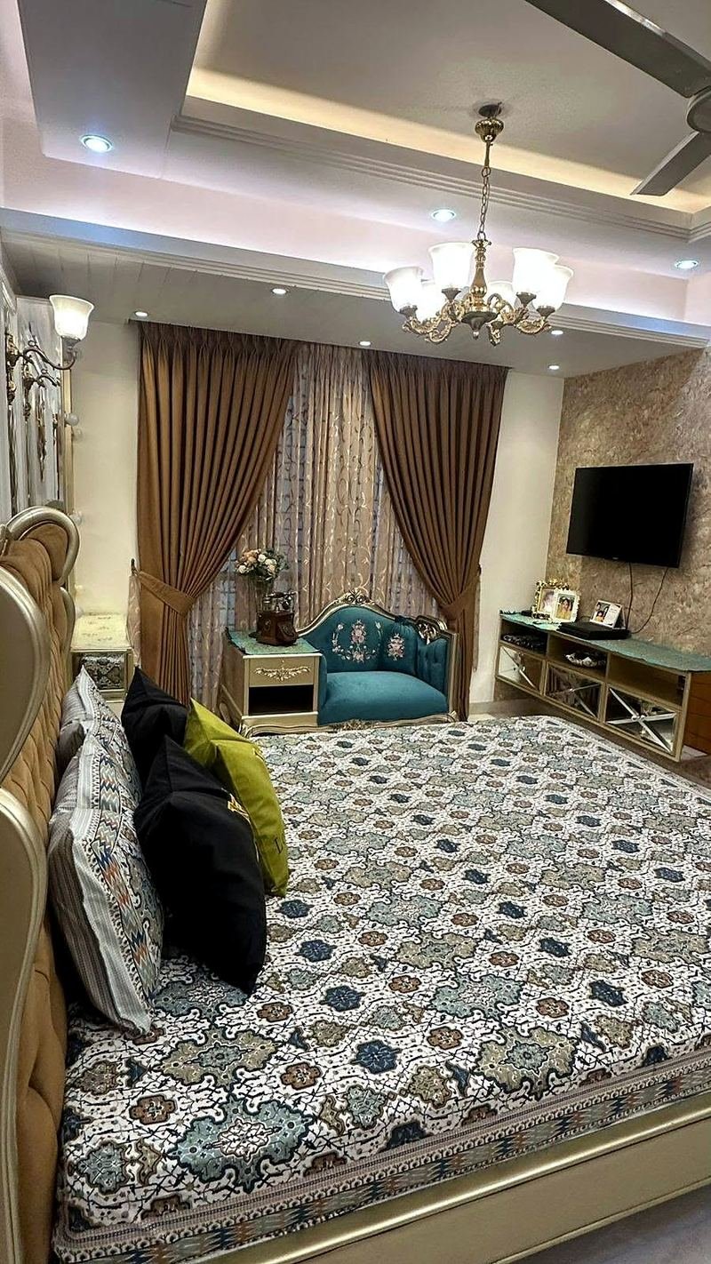 Another view of the bed and matching furniture in a champagne finish