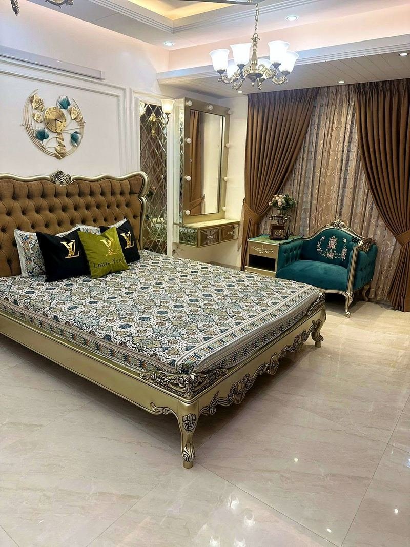 Bed and matching furniture in a champagne finish in a family bedroom